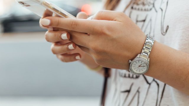 woman using mobile phone one of our tips for new students in Vancouver